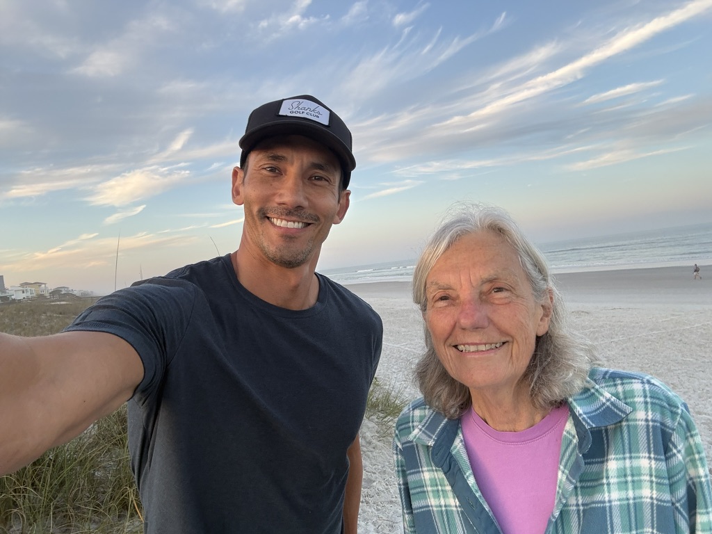 David and his mom on the beach at sunrise
